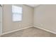 Cozy carpeted bedroom features a window and neutral walls at 24220 W Ripple Rd, Buckeye, AZ 85326