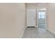 Home's entryway with tile flooring and doorway to a carpeted room at 24220 W Ripple Rd, Buckeye, AZ 85326