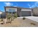 Attractive single-story home showcasing stone accents, desert landscaping, and a two-car garage at 24220 W Ripple Rd, Buckeye, AZ 85326