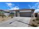 Inviting single-story residence with stone detailing, low-maintenance landscaping, and a two-car garage at 24220 W Ripple Rd, Buckeye, AZ 85326