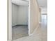 Hallway featuring neutral colors, tile flooring, and an open doorway to a carpeted room at 24220 W Ripple Rd, Buckeye, AZ 85326