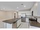 Spacious kitchen featuring white cabinets, stainless steel appliances, and a dark countertop island at 24220 W Ripple Rd, Buckeye, AZ 85326