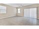 Bright living room with tile flooring, a ceiling fan, and large sliding glass doors at 24220 W Ripple Rd, Buckeye, AZ 85326