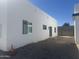 Exterior side view of modern white home with minimalist rock landscaping at 2440 W Morten Ave, Phoenix, AZ 85021