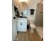 Bathroom featuring a modern sink, toilet, oval mirror, and gray tiled shower at 2440 W Morten Ave, Phoenix, AZ 85021