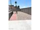 Backyard with a rock landscape, modern fence, and clear blue skies at 2441 W Morten Ave, Phoenix, AZ 85021