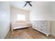 Guest bedroom with a bed and dresser accented by wood-look floors at 2441 W Morten Ave, Phoenix, AZ 85021