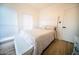 Cozy bedroom with a comfortable bed, white headboard, and a window providing natural light at 2441 W Morten Ave, Phoenix, AZ 85021