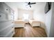 Bedroom with two beds and dresser accented by wood-look floors and ceiling fan at 2441 W Morten Ave, Phoenix, AZ 85021