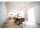 Open-concept dining area with wood floors, modern table, and chairs next to sliding glass doors at 2441 W Morten Ave, Phoenix, AZ 85021