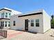 Modern home exterior featuring clean lines, neutral colors, and a well-maintained front yard at 2441 W Morten Ave, Phoenix, AZ 85021