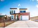 Contemporary two-story house with brick accents, a second story balcony, and modern curb appeal at 2441 W Morten Ave, Phoenix, AZ 85021