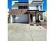 Modern two-story home with a brick accent wall, a balcony, and two-car garage at 2441 W Morten Ave, Phoenix, AZ 85021