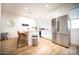 Modern kitchen with stainless steel appliances, white cabinets, and a breakfast bar with seating at 2441 W Morten Ave, Phoenix, AZ 85021