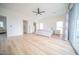 Bright main bedroom features a ceiling fan, light wood floors, and a sliding glass door at 2441 W Morten Ave, Phoenix, AZ 85021