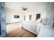 Bright main bedroom features a ceiling fan, dresser, and wood-look flooring at 2441 W Morten Ave, Phoenix, AZ 85021