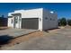 Modern single-story home featuring a gray garage door and drought-tolerant landscaping at 2444 W Morten Ave, Phoenix, AZ 85021