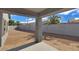 View of an empty backyard with a concrete patio and dirt ground at 2524 N Pony Ln, Casa Grande, AZ 85122