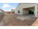 Spacious backyard ready for landscaping, featuring a covered patio and privacy wall at 2649 N Riverside Dr, Florence, AZ 85132