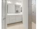 A bathroom with a double sink vanity and a view into the walk-in shower at 2649 N Riverside Dr, Florence, AZ 85132