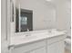 A bathroom with a double sink vanity and a view into the shower and toilet area at 2649 N Riverside Dr, Florence, AZ 85132