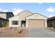 Beige single-story home with desert landscaping and a two-car garage at 2649 N Riverside Dr, Florence, AZ 85132