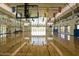 Bright and spacious gymnasium featuring hardwood floors, high ceilings, and ample natural light at 2649 N Riverside Dr, Florence, AZ 85132