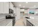 Modern kitchen with stainless steel appliances, white cabinets, and granite countertops at 2649 N Riverside Dr, Florence, AZ 85132