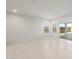 Bright living room with tile floors, two windows, and glass sliding doors at 2649 N Riverside Dr, Florence, AZ 85132