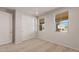 Clean bedroom with windows offering a view of the outdoors and a closet with sliding doors at 26957 W Lone Cactus Dr, Buckeye, AZ 85396