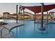 Resort-style pool with shade structures at the community clubhouse at 26957 W Lone Cactus Dr, Buckeye, AZ 85396