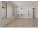 Well-lit living room with built-in shelving, neutral paint, and a large window offering natural light at 26973 W Lone Cactus Dr, Buckeye, AZ 85396