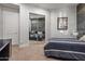 Well-lit bedroom with a rustic accent wall, queen bed, and a mirrored closet at 27582 N 67Th Way, Scottsdale, AZ 85266