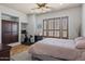 Comfortable bedroom with hardwood floors, plantation shutters, and neutral decor at 27582 N 67Th Way, Scottsdale, AZ 85266