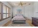 Cozy bedroom featuring hardwood floors, a ceiling fan, and lots of natural light at 27582 N 67Th Way, Scottsdale, AZ 85266