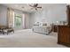 Expansive primary bedroom with neutral palette, ceiling fan, and large window at 27582 N 67Th Way, Scottsdale, AZ 85266