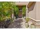 Welcoming front entrance with stone accents, potted plants, and decorative water feature at 27582 N 67Th Way, Scottsdale, AZ 85266