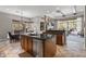 Open-concept kitchen with breakfast bar, stainless steel appliances, and stone accents on fireplace at 27582 N 67Th Way, Scottsdale, AZ 85266