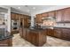 Spacious kitchen with dark wood cabinetry, stainless steel appliances, and granite countertops at 27582 N 67Th Way, Scottsdale, AZ 85266