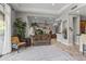 Bright, open living room with tile flooring, neutral walls, and decorative plants throughout the space at 27582 N 67Th Way, Scottsdale, AZ 85266