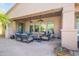 Outdoor patio with comfortable seating, overhead fans, and string lighting at 27582 N 67Th Way, Scottsdale, AZ 85266