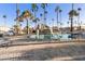 Large pool featuring a gradual entry and a seated lift; surrounded by palm trees and lounge chairs at 2929 E Main St # 135, Mesa, AZ 85213