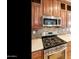 Close-up of a kitchen featuring stainless steel oven, stovetop, and tile backsplash at 2929 E Main St # 135, Mesa, AZ 85213