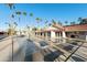 Community shuffleboard court next to building, complemented by lush palm trees and clear blue skies at 2929 E Main St # 135, Mesa, AZ 85213