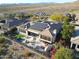 Drone shot of a property with solar panels, a swimming pool, an outdoor kitchen and lush landscaping at 3109 W Summit Walk Ct, Anthem, AZ 85086