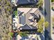 Aerial view showcases the back of a home with a solar panel system, pool, lush landscaping and patio at 3109 W Summit Walk Ct, Anthem, AZ 85086