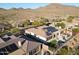 An aerial view of a desert home with a pool, solar panels, and a cozy backyard patio area at 3109 W Summit Walk Ct, Anthem, AZ 85086