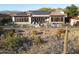 Backyard view of home featuring solar panels, a pool, and outdoor seating area in a desert landscape at 3109 W Summit Walk Ct, Anthem, AZ 85086