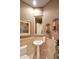 Compact bathroom with pedestal sink, decorative sconces, and neutral colored walls at 3109 W Summit Walk Ct, Anthem, AZ 85086