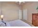 Bedroom showcasing neutral walls, a ceiling fan, and a comfortable bed with patterned bedding at 3109 W Summit Walk Ct, Anthem, AZ 85086